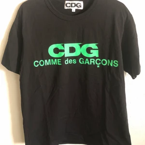 Classic CDG / Comme Des Garçons Logo Tee - Classic CDG / Comme Des Garçons Neon Logo T-Shirt  Size large, fits like a regular men’s medium tee.  Excellent condition, no flaws or damage.  DM if you need exact size measurements.    Buyer pays for all shipping costs. All items sent with tracking number.   No swaps, no trades, no offers. 