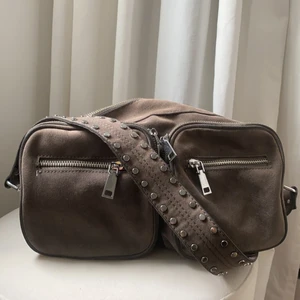 Handväska - Handväska i grå/brun färg med silver detaljer. Bra skick!! Från märket noella i den större modellen. Skriv för fler bilder eller andra frågor. 📦Köparen står för frakt📦