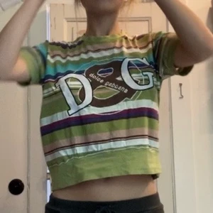 Dolce & Gabbana T-shirt - Randig t-shirt med dolce&gabbana tryck på fram och baksida! antagligen inte äkta men den är jättefin endå. Trycket på framsidan är broderat och det på baksidan är sytt på. Storleken är L men den sitter bra på mig som är S, lite löst. skriv vid frågor! 💚💚