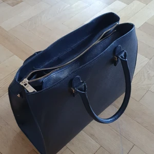 H&M Lady bag - Black bag from H&M with golden zipper and details. Very spacious inside- fits a laptop for example. Has two inner pocketa. Used once