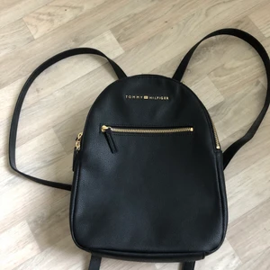 Svart liten Tommy Hilfiger ryggsäck  - Köpte denna ryggsäck när jag var i USA 2018 har dock aldrig fått användning av denna väskan trots att den är väldigt fin. Köpt för 800kr!