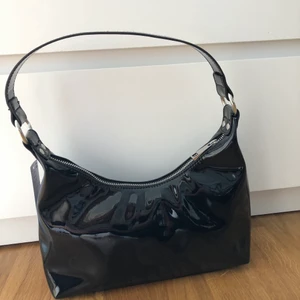 Supersnygg väska från ginatricot - Supersnygg väska från ginatricot i lack-material, perfekt nu till sommaren!! 