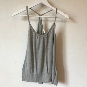 Grått linne med flätade band, XS-S - Så mjukt och skönt linne med flätade band som  går ihop i ryggen! Fin detalj. Litet veckade detaljer även. Funkar för både XS och S. Kanske även M. Kan mötas i Stockholm eller skicka mot fraktkostnad! ✨🌸✨