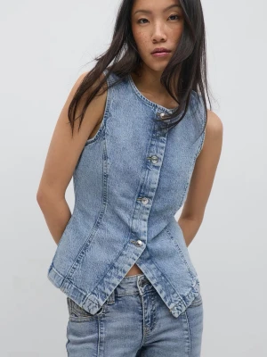 Jeansväst med knappar - Aldrig använd, helt ny, köpt för 400. Snygg ljusblå jeansväst i figurnära modell med markerad midja och silverfärgade knappar framtill. Västen har klassisk denimlook och är helt ärmlös, perfekt för att skapa en cool lager-på-lager-stil.