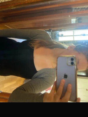 Grå bolero med långa ärmar - Snygg grå bolero med långa ärmar och öppen front. Perfekt att slänga över ett linne eller klänning för en enkel layering-look. Tunn och mjuk i materialet, vilket gör den skön att bära inomhus eller under jacka.