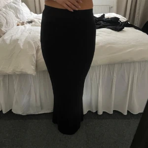 Svart långkjol i glittrigt tyg - Säljer en svart långkjol med glittrigt tyg som ger en snygg och elegant look✨