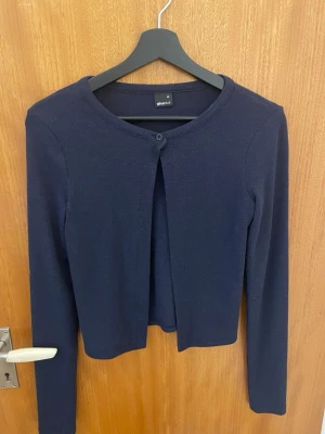 Mörkblå kofta från Gina Tricot - Stilren mörkblå kofta från Gina Tricot. Enkel och klassisk design som funkar till allt. Den är i storlek xs.