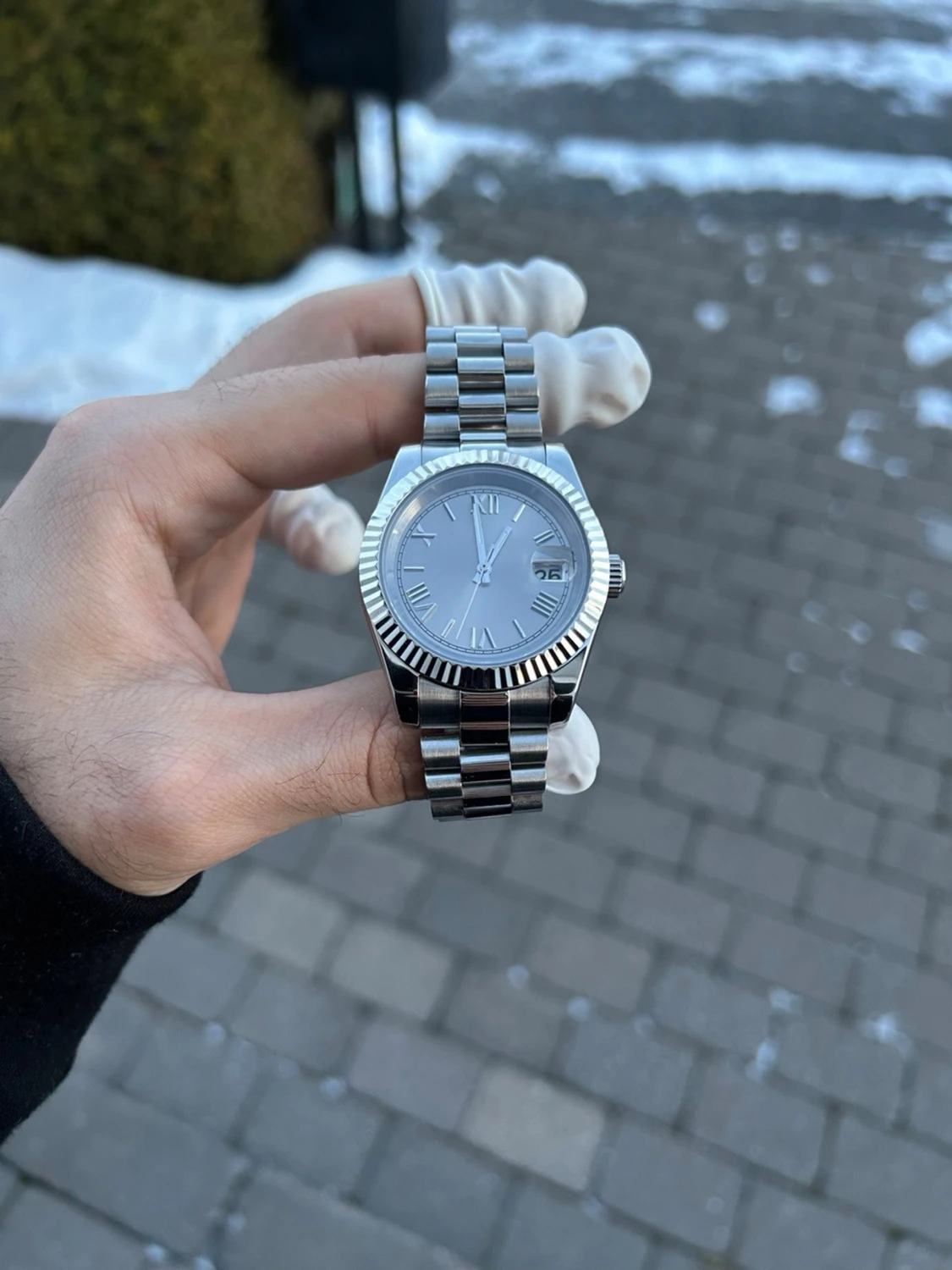 Silverfärgad klocka med datumfönster