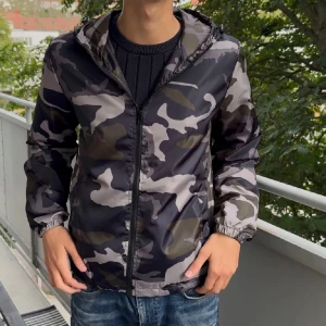Camo windbreaker/höstjacka -  Säljer en snygg vind/höstjacka från Lindfors i camoflage mönster med dragkedja och huva. Perfekt för de kyligare vädret nu. Aldrig använd