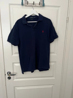 Ralph lauren piké  - Säljer nu denna snygga ralph lauren pikén🤩 Det är storlek L och den är i bra skick✅ OBS:finns ett väldigt litet hål vid nacken men som knappt syns, skriv för bild🙌 tveka inte på att höra av dig ifall du har minsta fråga! 