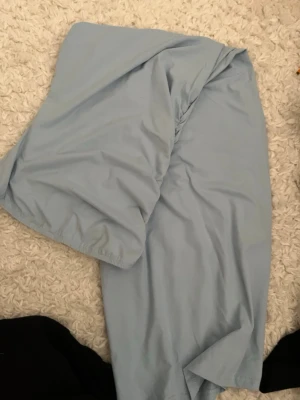 Ljusblå offshoulder klänning - Säljer ett par ljusblå offshoulder klänning i mjukt och tunt material. Klänningen har resår vid brösten och är perfekta för sommaren. Klassisk och enkel design utan mönster eller detaljer. Aldrig använd 