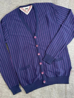 Vintage Lee Wool Cardigan Striped Button Up Knit Size M - Description: lee wool cardigan in deep blue/purple with pink stripes. clean y2k/preppy vibe with a slim slightly cropped fit. easy layering piece with buttons + pockets.  measurements (cm, laid flat): p2p 47, waist 34, s2s 42, length 47, sleeve 64.5  good vintage condition, light wear. colors may vary slightly due to lighting.