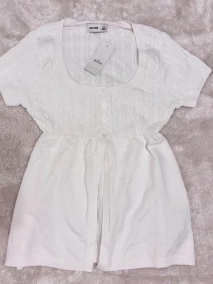 Hollister babydoll top - Knitted hollister babydoll top, new with tags. Size xs. Has a small stain as you can see in the fourth pic. 