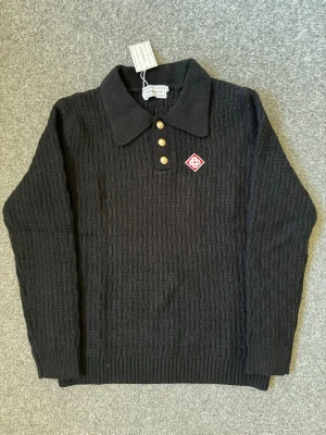 Casablanca black polo sweater - Size M, true to size. Very comfortable and fits perfectly.