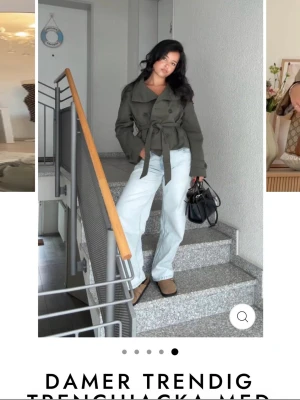 Olivgrön trenchcoat med knytskärp - Snygg olivgrön trenchcoat med dubbelknäppning och brett knytskärp i midjan. Jackan har klassisk krage, axelklaffar och två framfickor. Perfekt för dig som vill ha en trendig och stilren look. Passar till jeans eller kjol.