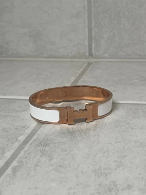 H armband - Snyggt armband i färgerna vit och rose gold. Armbandet är i mycket bra skick. Finns tyvärr inga tillbehör