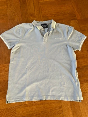 Ljusblå piké från Bondelid - Snygg och sällsynt piké från Bondelid i storlek L med clean ljusblå färg med vita detaljer. Inga defekter alls