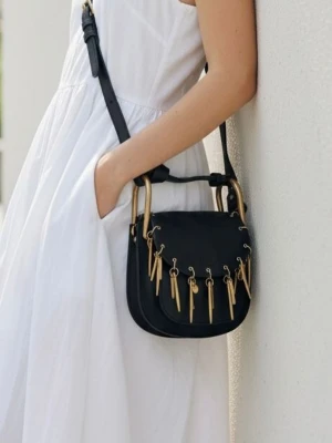 Chloé svart axelremsväska med gulddetaljer - Snygg svart handväska från Chloé i mjukt läder med justerbar axelrem. Väskan har unika guldfärgade metalldetaljer och dekorativa hängen framtill samt rundade former och guldfärgade handtag. Perfekt för dig som vill ha en statementväska med lyxig känsla.