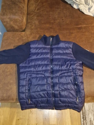 Moncler Cardigan Navy Hybrid (Lägg Bud Gärna) - Jag har en dålig mobil så kameran förstår hur den ser ut men den är riktigt fräsch igentligen. Kommer uppdatera med nya bättre bilder snart. Snygg moncler mörkblå pufferjacka med quiltad front och rygg samt stickade ärmar och krage. Perfekt för sommaren. Scannen på loggan funkar. Nypris Typ 10.000