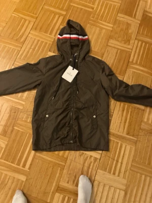 Moncler windbreaker grön  - Moncler windbreaker grön – storlek 2  Säljer en snygg och stilren Moncler windbreaker i grön färg, storlek 2 (motsvarar ungefär M). Jackan är lätt och perfekt för vår/sommar eller som ett extra lager. Klassisk Moncler-design med hög kvalitet och bra passform.