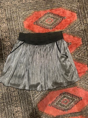 Zadig & volitare minikjol  - Snygg minikjol från Zadig & volitare i silvertyg med bred svart resår i midjan. Den är väldigt fint skick och knappt använt. 