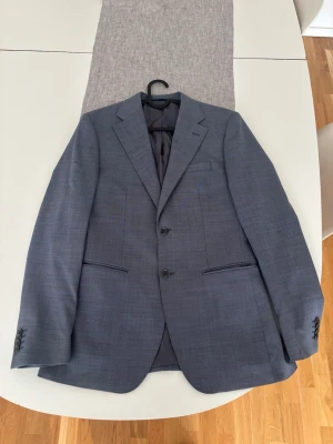 Blå kostymkavaj. Luciano blazer. - En luciano blazer från bläck, aldrig använd! Storlek 46. Slimad passform. Perfekt för en ungdomlig sommar. 