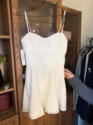 Vit kort klänning / studentklänning ny - Söt vit kort klänning med tunna axelband, perfekt till student, aldrig använd 