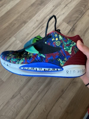 Nike kd 14’s ”Ky-d” colorway  - Unika Nike sneakers med färgglatt mönster i blått, rött, gult och grönt. Skon har en grön transparent rem över vristen, svart swoosh och blå sula med grafiska detaljer. Ovandelen är i textil och mesh, med röda detaljer vid hälen. Perfekt för dig som vill sticka ut. Använda en halv säsong säljer dem för jag köpte fel storlek