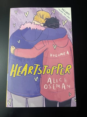 Heartstopper 4   - Heartstopper Volym 4 är en grafisk roman med färgstarkt illustrerat omslag i lila och rosa toner. Boken handlar om kärlek och vänskap mellan två killar och innehåller även stickers och en miniserie. Perfekt för dig som gillar romantik och HBTQ+-teman.