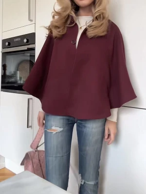 Vinröd capejacka med vida ärmar💖💖❤️ - Säljer en vinröd capejacka med vida, trekvartsärmar och en knapp framtill. Jackan har en lös och flowy passform som ger en cool och avslappnad look. Perfekt att slänga över en tröja för extra stilpoäng. Materialet ser ut att vara mjukt tyg.