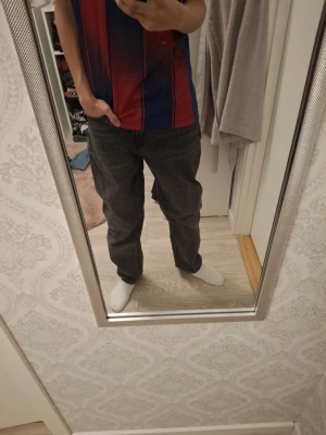 Svarta raka jeans - Säljer ett par svarta jeans med rak passform. Jeansen har klassisk femficksdesign och normal midja. Perfekta för dig som gillar en enkel och stilren look. Materialet är denim i bomull. L32