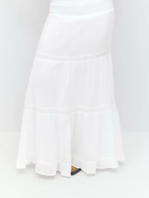 Vit långkjol med volangdetaljer - Obs andra bilden är min kjol inte första. Säljer en vit långkjol med bred resår i midjan och volangdetaljer. Kjolen har en luftig och flowy känsla, perfekt för varma dagar. Tillverkad i ett lätt material som ger en avslappnad och bohemisk vibe.