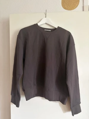 Our Legacy sweatshirt - En enkel och stilren mörkgrå sweatshirt från Our Legacy. Tröjan har rund halsringning, långa ärmar och ribbade muddar vid ärmslut och nederkant. Perfekt basplagg för en avslappnad look.