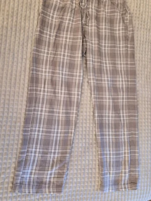 Rutiga pyjamasbyxor i grått och vitt - Mysiga pyjamasbyxor med gråvitt rutmönster och dragsko i midjan. 