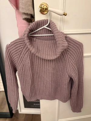 Ljuslila polotröja från KappAhl - Mysig stickad polotröja i ljuslila från KappAhl. Tröjan har grov ribbstickning, hög polokrage och långa ärmar. Perfekt för lager på lager och en chill look till hösten eller vintern.