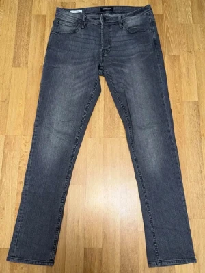 Säljer ett par Jack & Jones Glenn jeans Grey – Size W32 L32 - Jeansen är endast testad. I mycket bra skick utan synligt slitage.  Slim fit-modell (Glenn) med stretch som ger en snygg passform och hög komfort. Passar perfekt till både vardag och mer uppklädda tillfällen.  Size: W32 L32 🏷️ Rabatt vid köp av flera plagg!