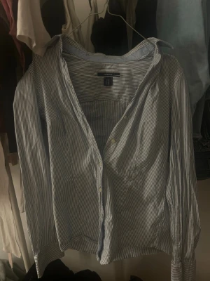 Blårandig skjorta från Gant - Klassisk blårandig skjorta från Gant med lång ärm och krage. Skjortan har knappar framtill och är tillverkad i mjuk bomull. Perfekt för en clean och stilren look.