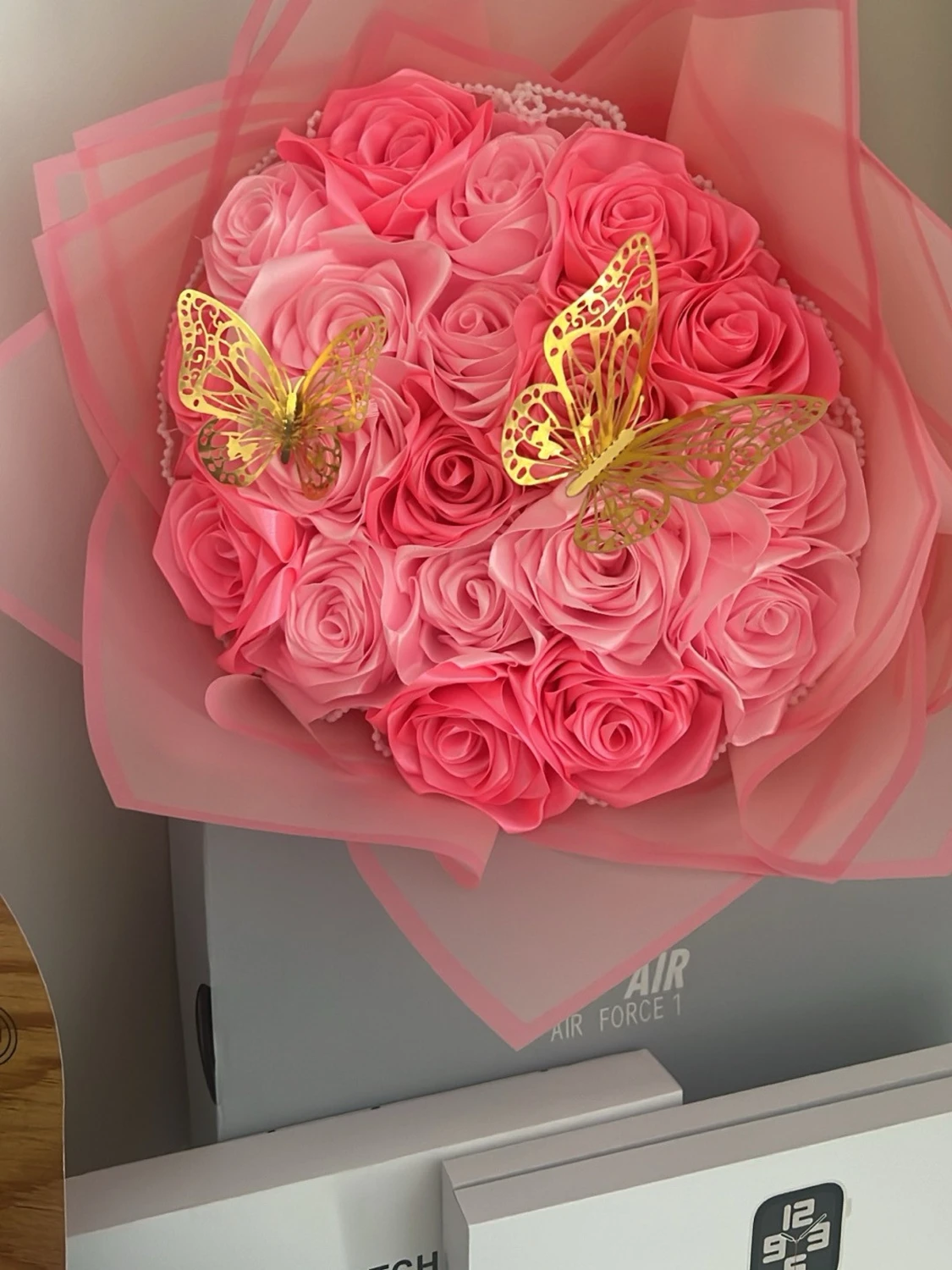 Bukett med rosa konstrosor och fjärilar