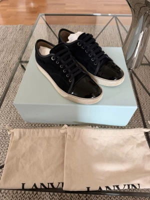 Lanvin Cap Toe Navy Blue  - Köpta på Farfetch för nåt år sedan, använda sparsamt. Finns ett synligt slitage vid sulan på vänstra skon (se på bild 6). Storlek UK 7 vilket motsvarar EU 41. Dessa skor är rätt stora i storleken så de passar även 42–42,5.  Nypris ligger på ≈ 5000 sek  Innersulans längd: 27,5 cm  Medföljer: Dustbags för båda skorna Extra skosnören Samt den feta versionen av boxen 😁