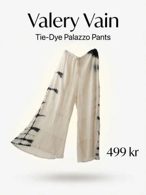 Tie-dye palazzobyxor Valery Vain - Vida palazzobyxor i linne från Valery Vain med snygg tie-dye effekt i svart och vitt. Byxorna har resår och dragsko i midjan för skön passform. Perfekta för en avslappnad och trendig look.