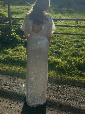 Balklänning  - Säljer min vackra balklänning från Bubbleroom. Storlek S. Den är uppsydd och justerad i midjan. Jag är 161 cm och den är ändå lite lång på mig som man ser på bilderna. Den har öppen rygg och en dragkedja vid rumpan. Den har även snörning för att kunna justera urringningen själv vid halsen. Glittrar otroligt vackert i solen!😍