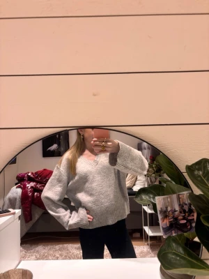 Ljusgrå stickad tröja med v-ringning - Mysig ljusgrå stickad tröja med djup v-ringning. Änvänd få gånger, är från Ginayoung i storlek 158/164.