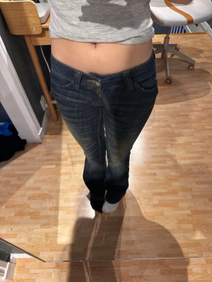 Mörkblå low waist weekday jeans  - Säljer ett par mörkblå jeans från weekday med låg midja. Jeansen har smal passform och snygga slitningar framtill. Materialet är mjukt denim som sitter skönt och följsamt. Perfekta för dig som gillar stilrena och tidlösa jeans. i storlek 25/30 