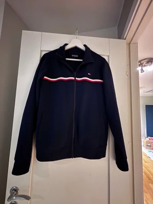Tommy Hilfiger zip hoodie - En fet full zip från varumärket Tommy Hilfiger. Den är trendig och inte mycket använd. Priset är ej hugget i sten. Skriv vid frågor!🤗 