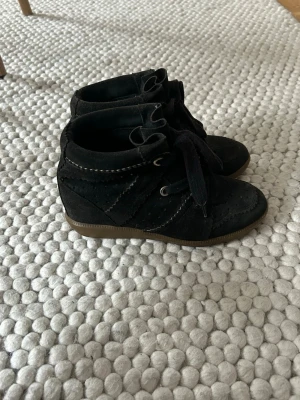 Isabel marant stövletter med snörning - Säljer ett par svarta isabel marant stövletter i mocka. Perfekta för dig som gillar en enkel men snygg look.
