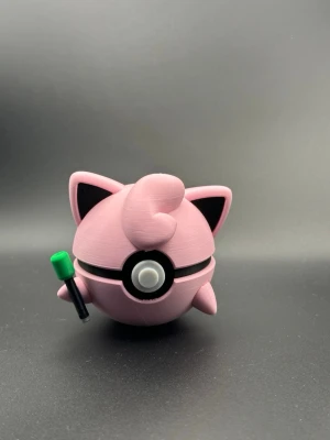 Rosa Jigglypuff Pokéboll-figur - En unik, specialdesignad Pokéboll inspirerad av Jigglypuff. Perfekt som dekoration i spelrummet, på skrivbordet eller som en gåva till Pokémon-fantasten.  Gjord av PLA (plast). 3D-utskriven med fina detaljer. Bollens mittknapp och kinder ger ett autentiskt uttryck. Nyskick/Nyproducerad.  Passa på att köpa till stället jag även säljer för att visa upp ditt favoritkort vid sidan av bollen :) Letar du efter en annan pokemon? Kolla bland mina annonser eller skriv till mig! 