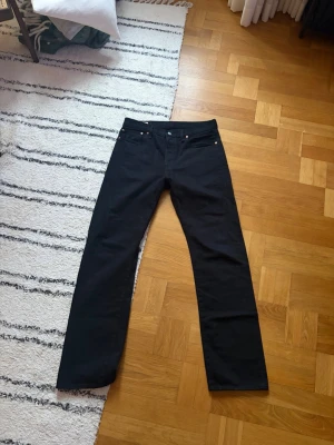 Svarta raka jeans från Levi's - Säljer ett par svarta jeans från Levi's med rak passform och klassisk femficksdesign. I princip inte använda mer än 5 gånger, och därav i helt nytt skick