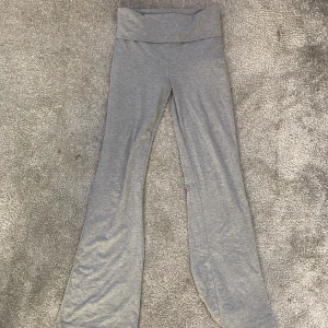 Grå yoga pants från Gina Tricot - Säljer ett par grå yoga pants från Gina Tricot. De har en bekväm passform med utsvängda ben och så att man kan vika ner dem 