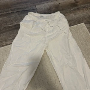 Vita mjukisbyxor med resårmidja - Säljer ett par vita mjukisbyxor med resår i midjan och avslappnad passform. Perfekta för en chill dag hemma eller när du vill vara bekväm. Byxorna är gjorda i bomull och har en enkel, stilren look.