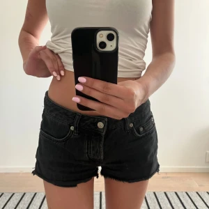 Svarta jeansshorts - Snygga svarta jeansshorts från 157. Shortsen har låg midja och en normal passform, perfekta för varma dagar. Stängs med 3 knappar och dragkedja framtill. Säljer då de är lite stora på mig!